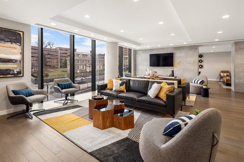 a living room with couches and chairs and a television